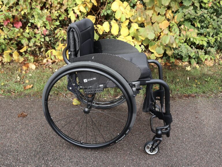 Side profile photo of a 'Rehasense Icon 60' lightweight adjustable self propelling wheelchair.