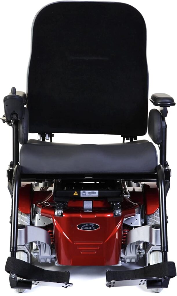Profile image of a 'Quickie Salsa M' electric wheelchair. The base of the wheelchair is in a dark metallic orange colour.