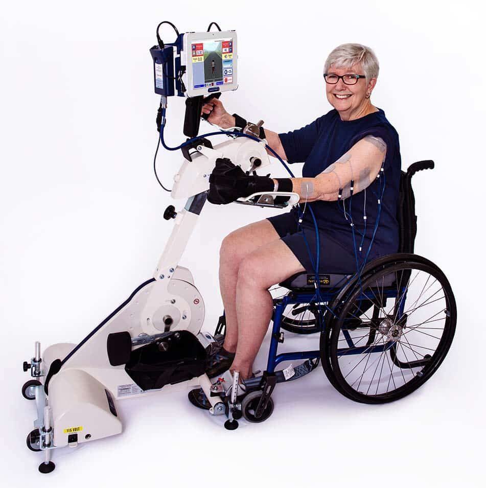 Rt300 slsa lady demonstrating fes system for arms from her wheelchair - Image from Access Your Life