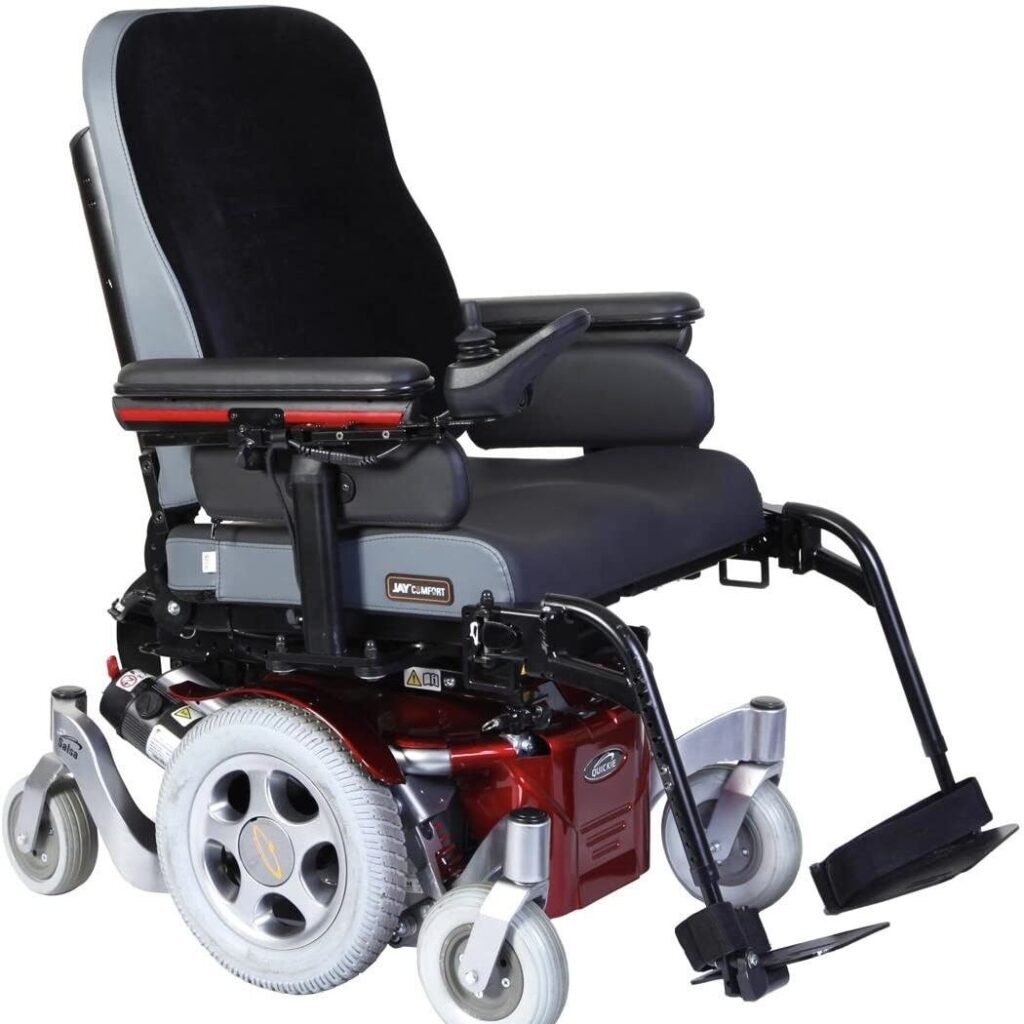 Side profile image of a 'Quickie Salsa M' electric wheelchair, with its distinct metallic orange frame & highlights.
