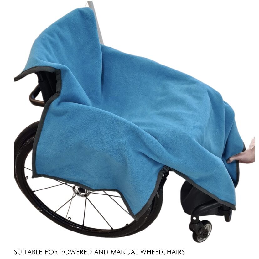 Photo of an 'AbleDry' blue wheelchair towel covering a self-propelling wheelchair. The towel cover the entire backrest and seat of the wheelchair, overhangs on top of the backrest and armrests and also extends down to cover up the footrests.