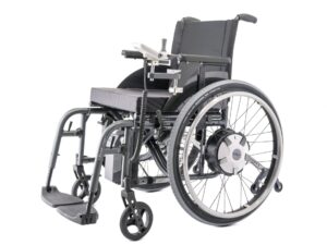 Side profile photo of a wheelchair with a 'Alber E-Fix E35' Electric wheelchair attachment wheels & controller attached. The silver white colour of the attachments identify it as originally separate from the wheelchair, whose frame is a darker, more metallic, grey colour.