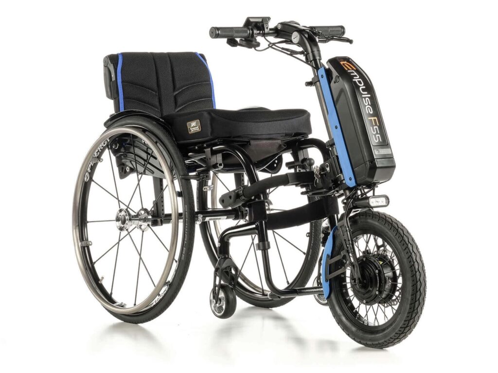 Side profile photo of an 'Empulse F55' powered bike-style add-on attachment for wheelchairs, attached to a self-propelling wheelchair.