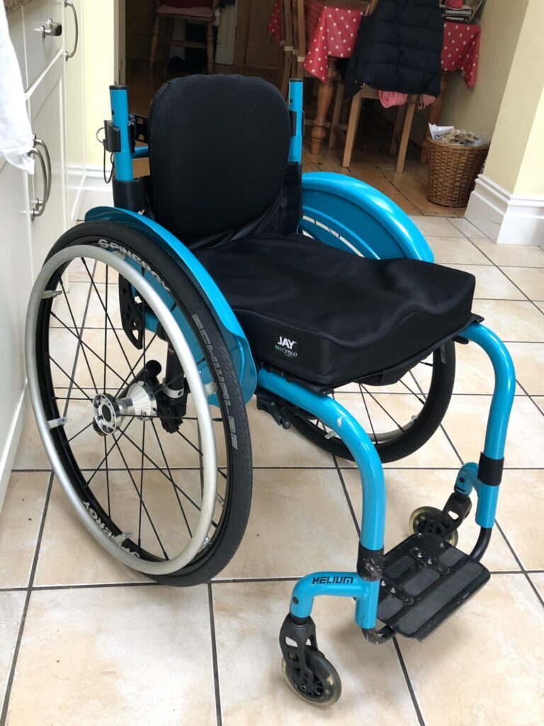 Profile photo of a 'Quickie Helium' self-propelling wheelchair.