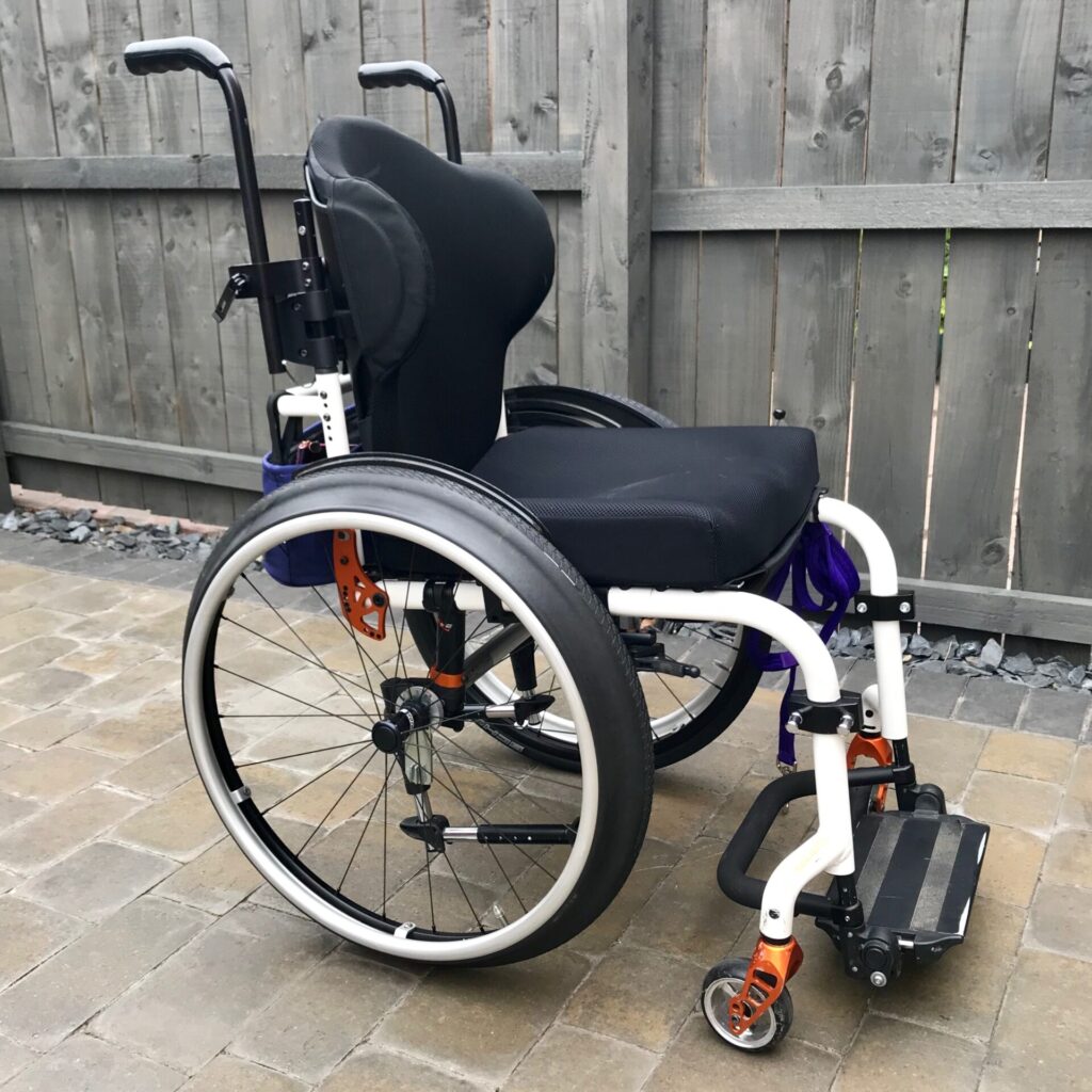Side profile photo of a 'Quickie Helium' rigid self-propelling wheelchair.