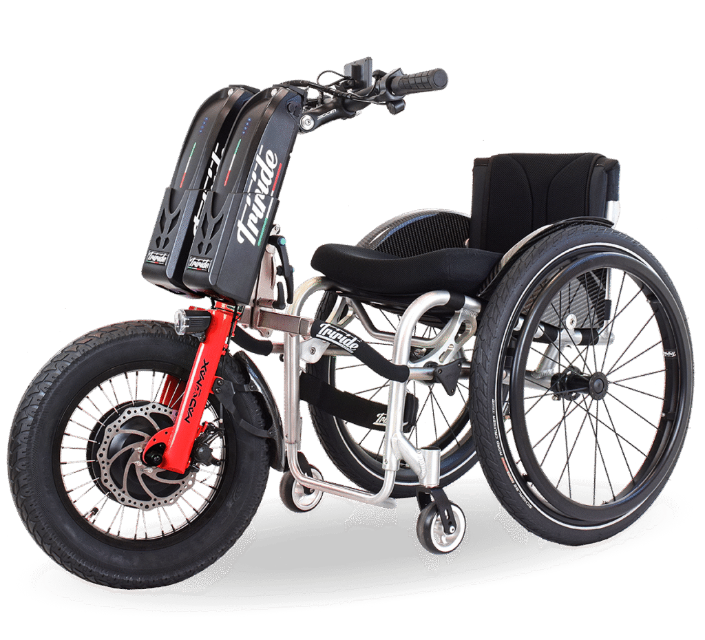 Side profile image of a 'Triride Mad Max' bike-style power add-on connected at the front, to a self-propelling wheelchair.