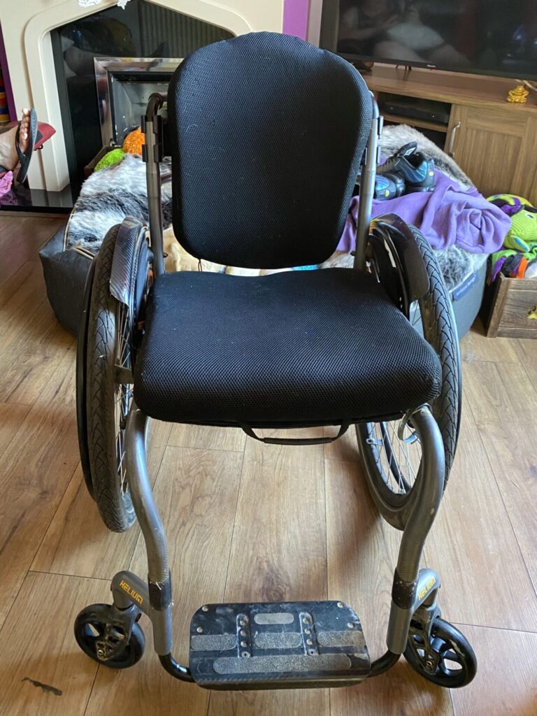 Profile photo of a 'Quickie Helium' self-propelling wheelchair.